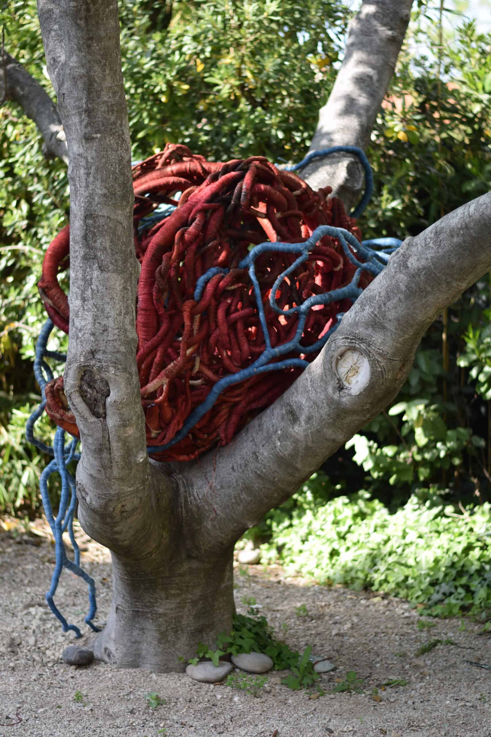Giant heart-shaped sculpture in a fig tree at Villa Datris foundation for contemporary sculpture by Aude Franjou