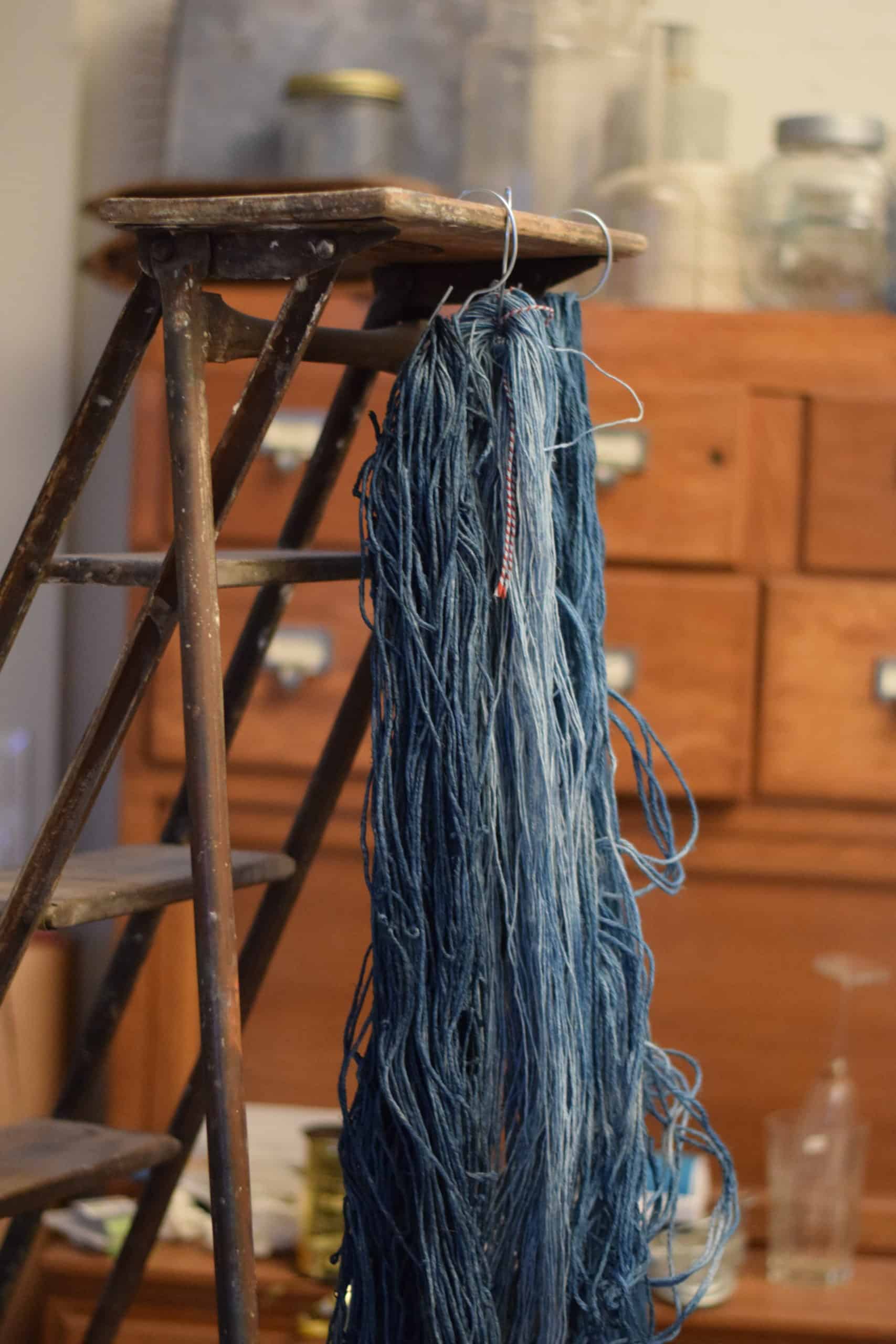 Picture of balls of blue string drying on a stepladder in Aude Franjou's workshop