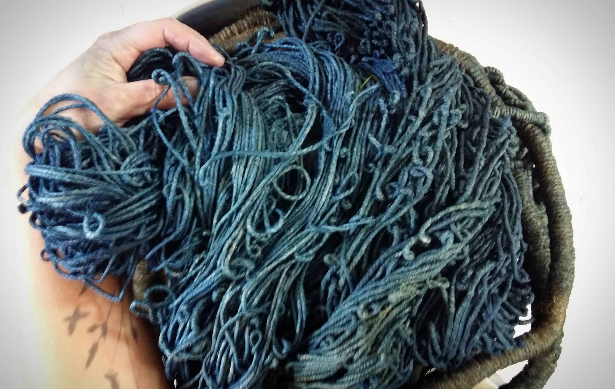 Picture of balls of indigo blue string, raw materials of sculptures.