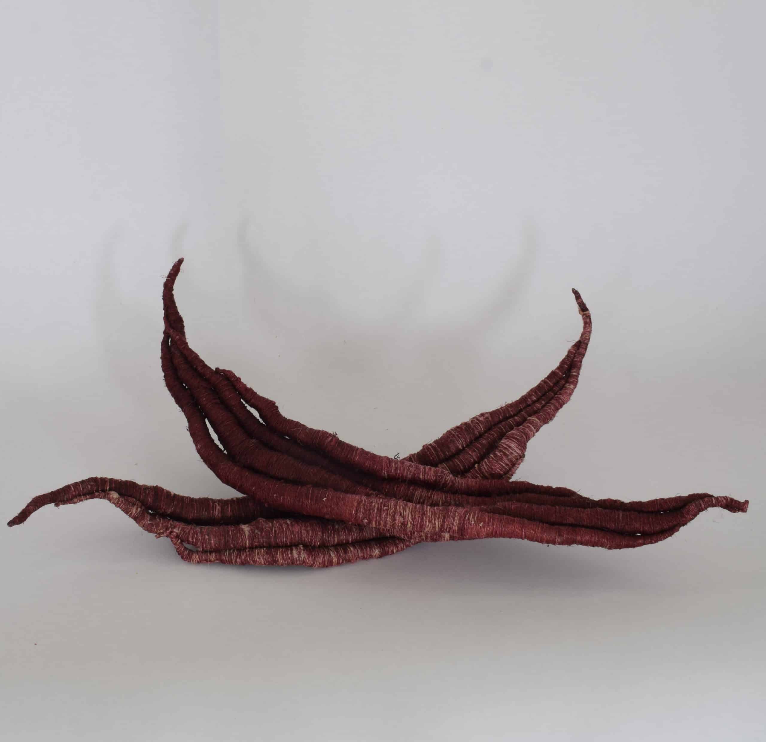 Picture of burgundy red sculpture resembling seeds by Aude Franjou