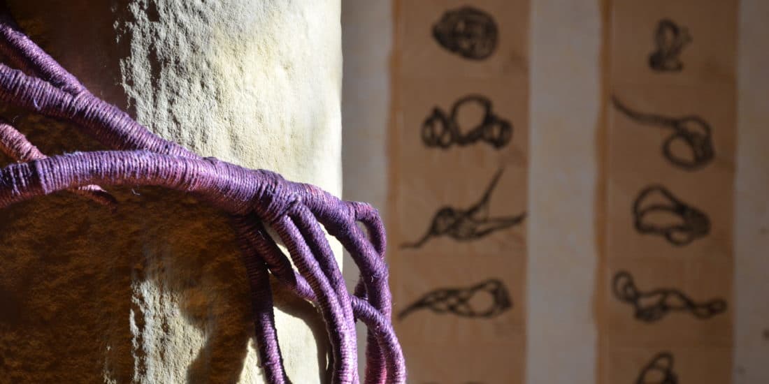 purple vine like sculpture on stone pillar by sculptor Aude Franjou in Vivoin, France