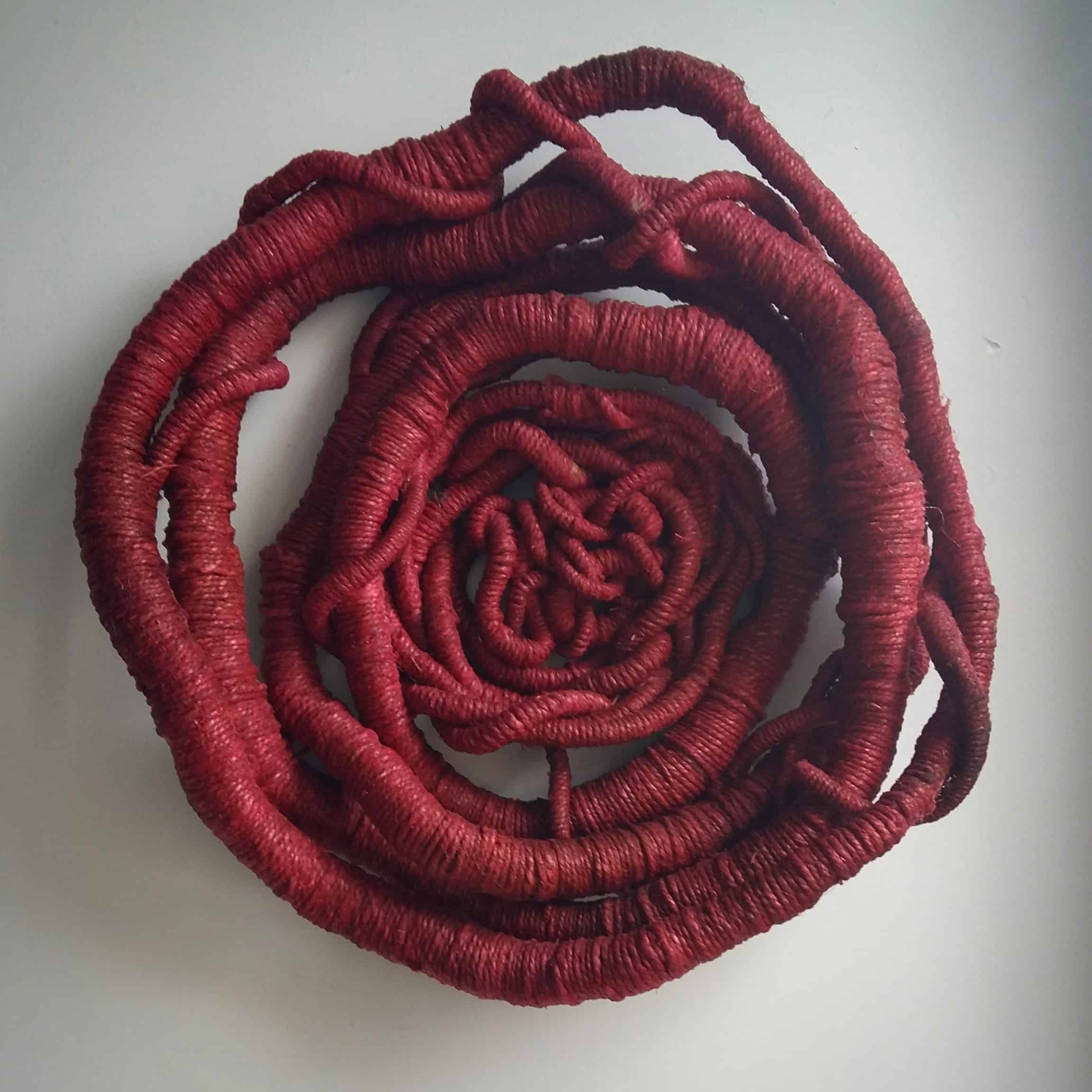 Picture of a red sculpture by artist Aude Franjou. The sculpture looks like a red blossom